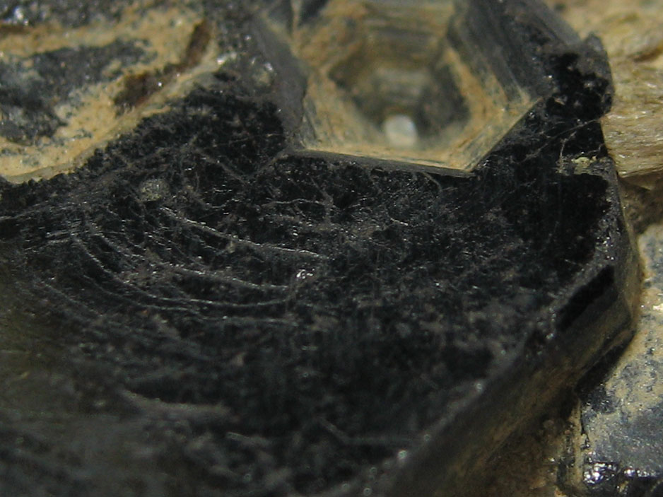 This is a macro image of Tantalite, from Poland, which can be found on the MIROFOSS database.